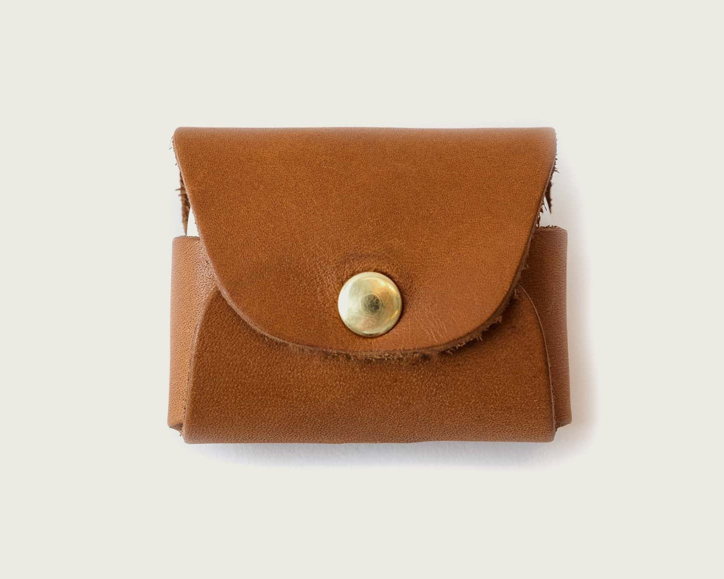 WP Standard’s tan leather AirPods case with brass snap.