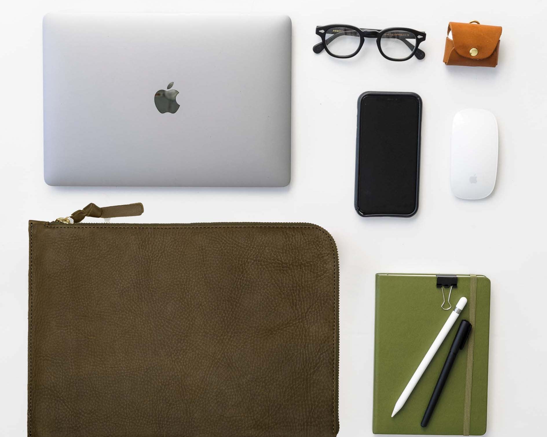 Leather laptop sleeve alongside daily essentials, offering sleek protection and effortless organization for work created by WP Standard.