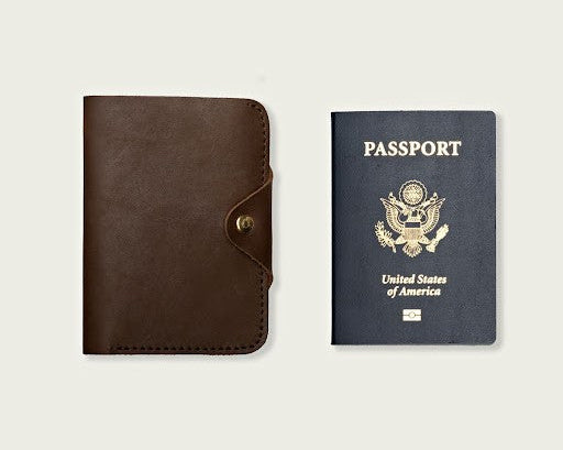 A tan passport wallet from WP Standard and a US passport captured together in a frame. 