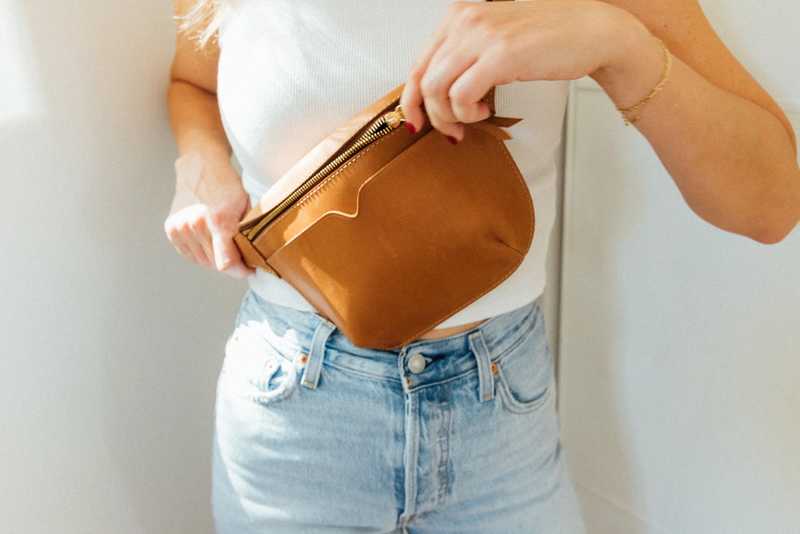 A woman in denim and a white tee wearing the WP Standard Sling Bag across her chest.