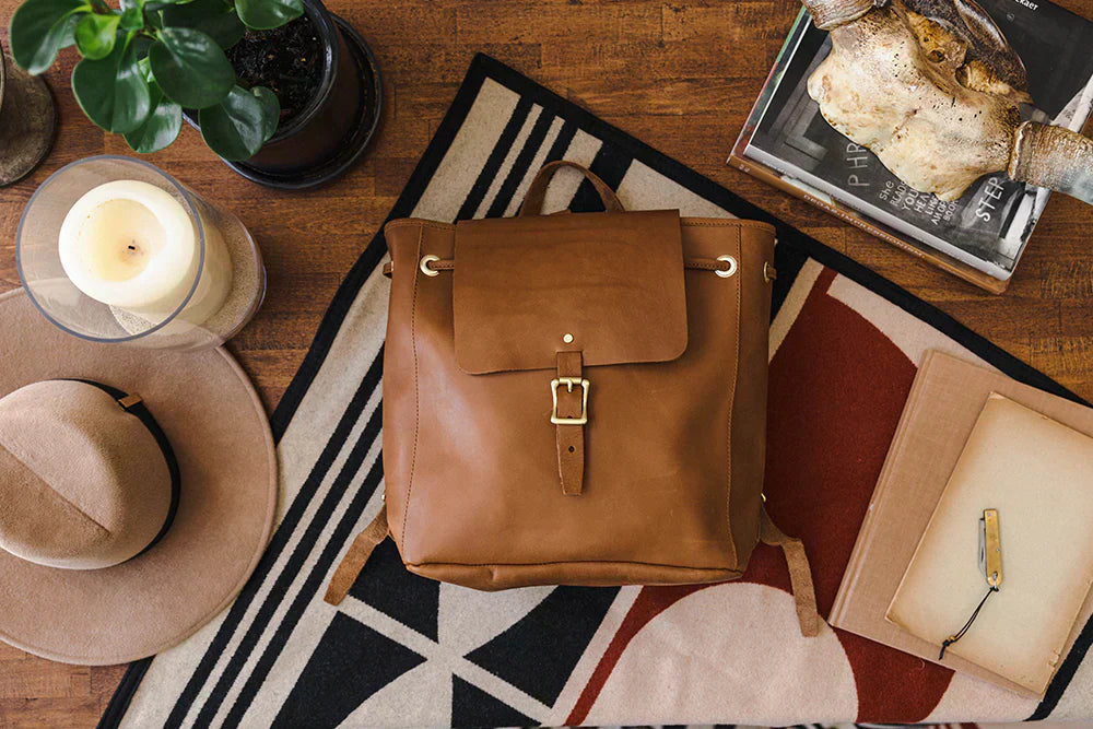 A WP Standard leather backpack placed on a table.