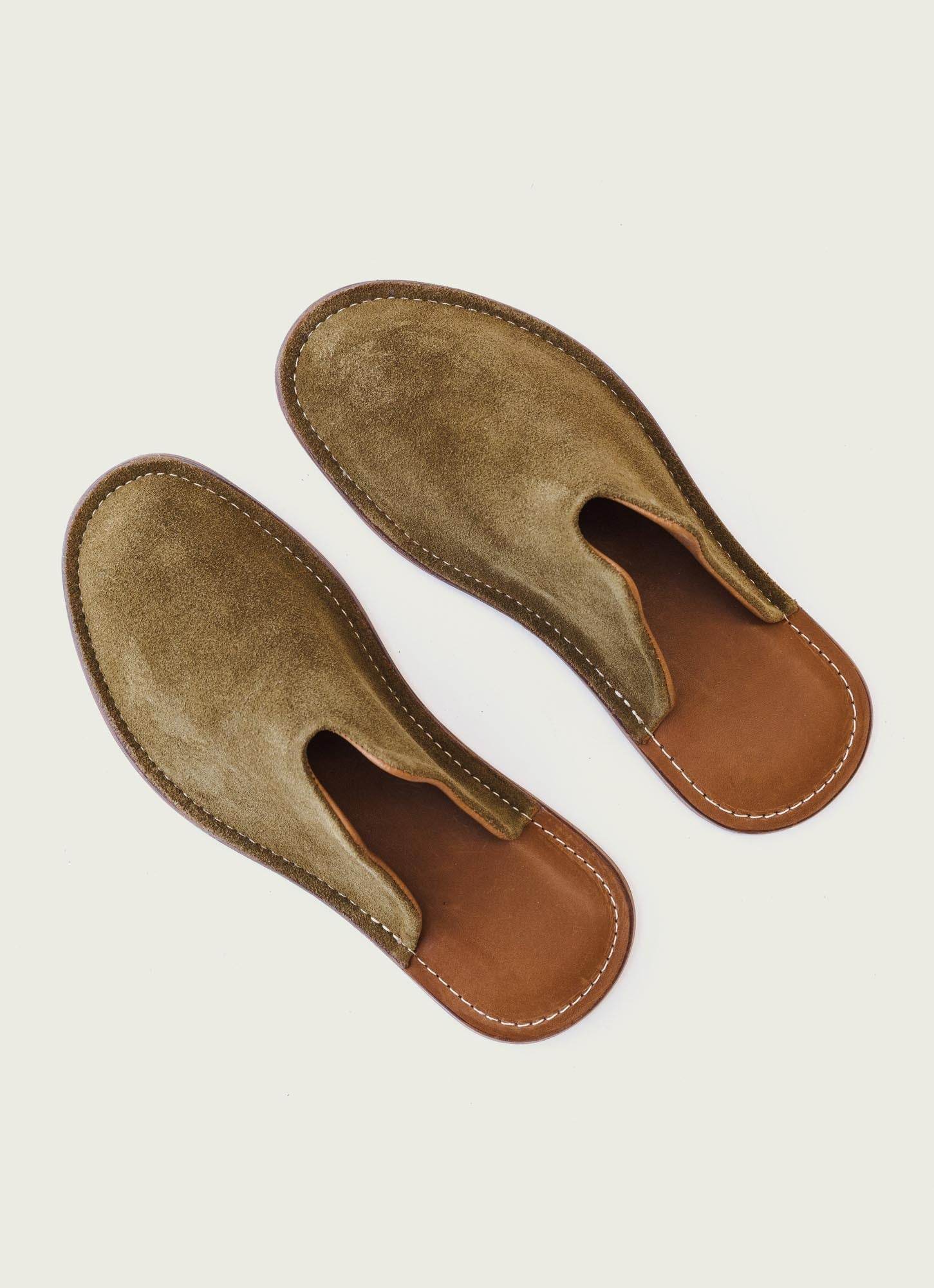 Handcrafted olive green suede slip-on slippers with brown sole and white stitching – premium quality unisex footwear for comfort and style.