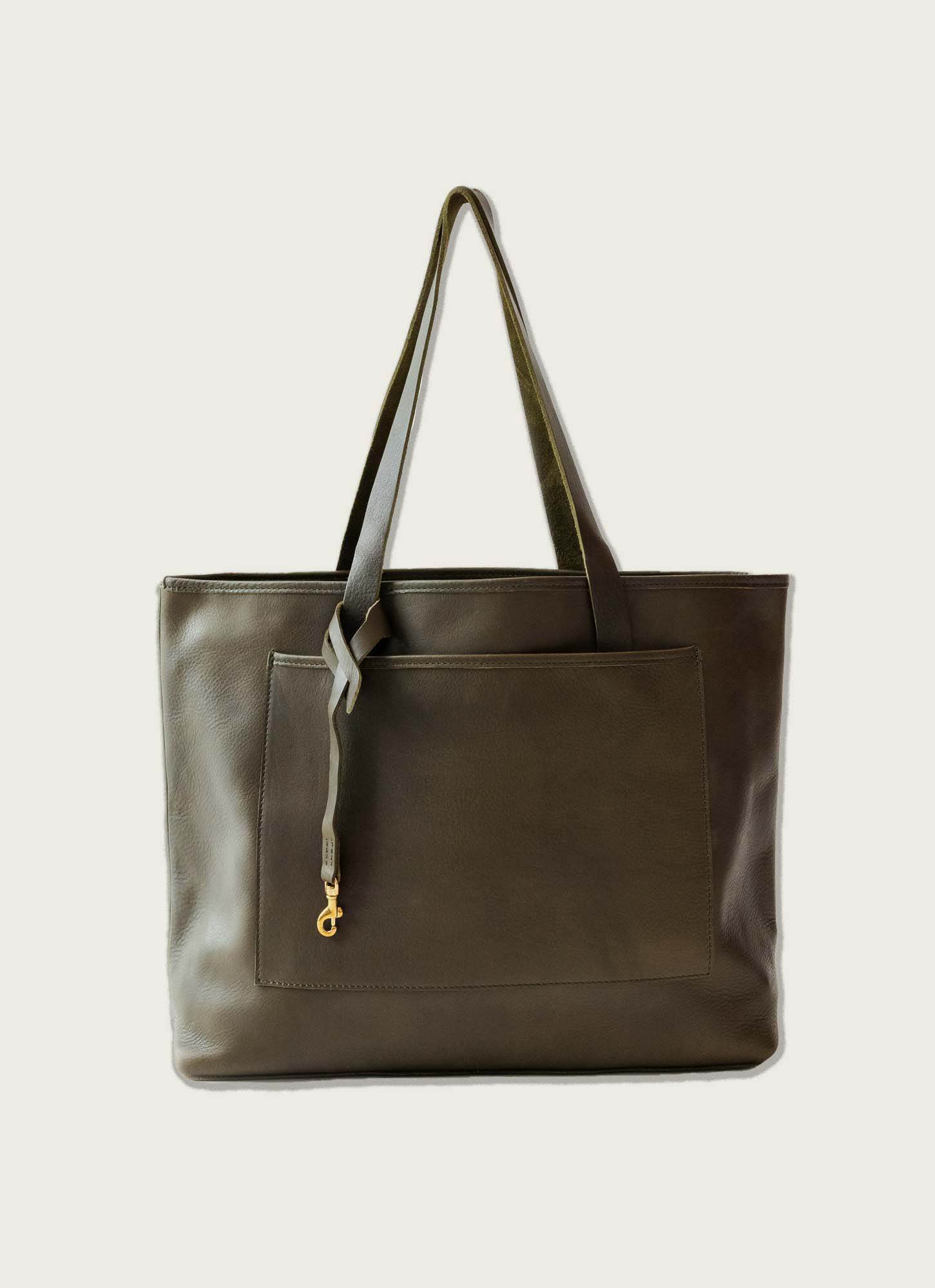 Dark olive full-grain leather tote with exterior pocket, long handles, and gold-tone clasp detail for everyday use.