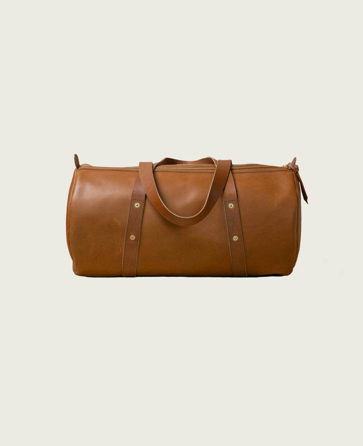 Vintage-inspired full-grain leather gym bag with zip-top and sturdy handles.