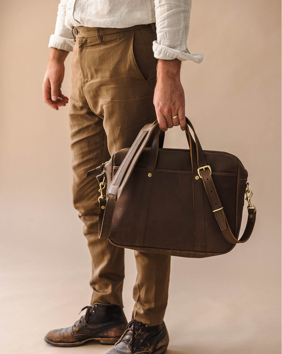brown leather briefcase with debossed logo