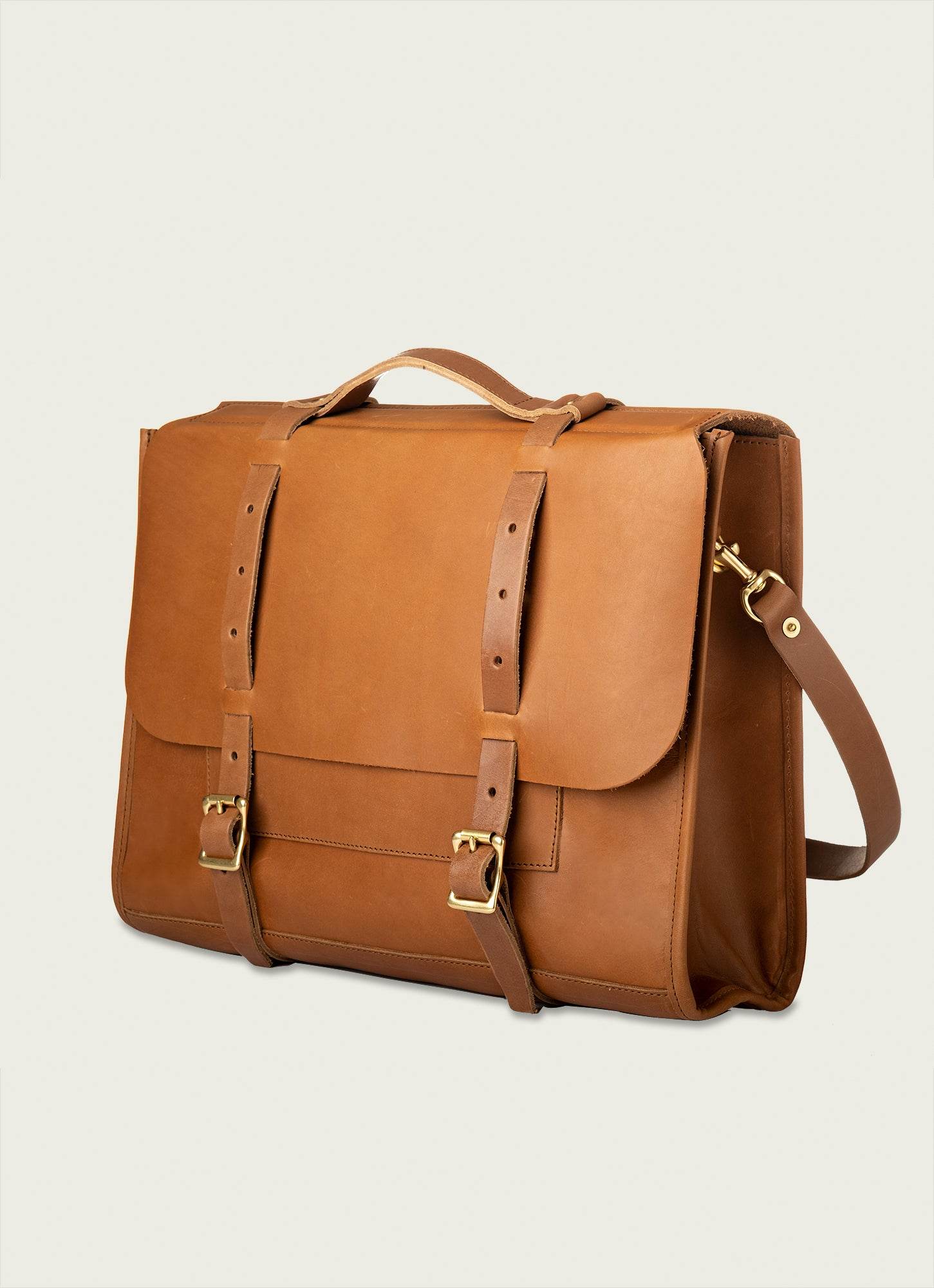 Full-grain leather briefcase with brass hardware and classic buckle straps.