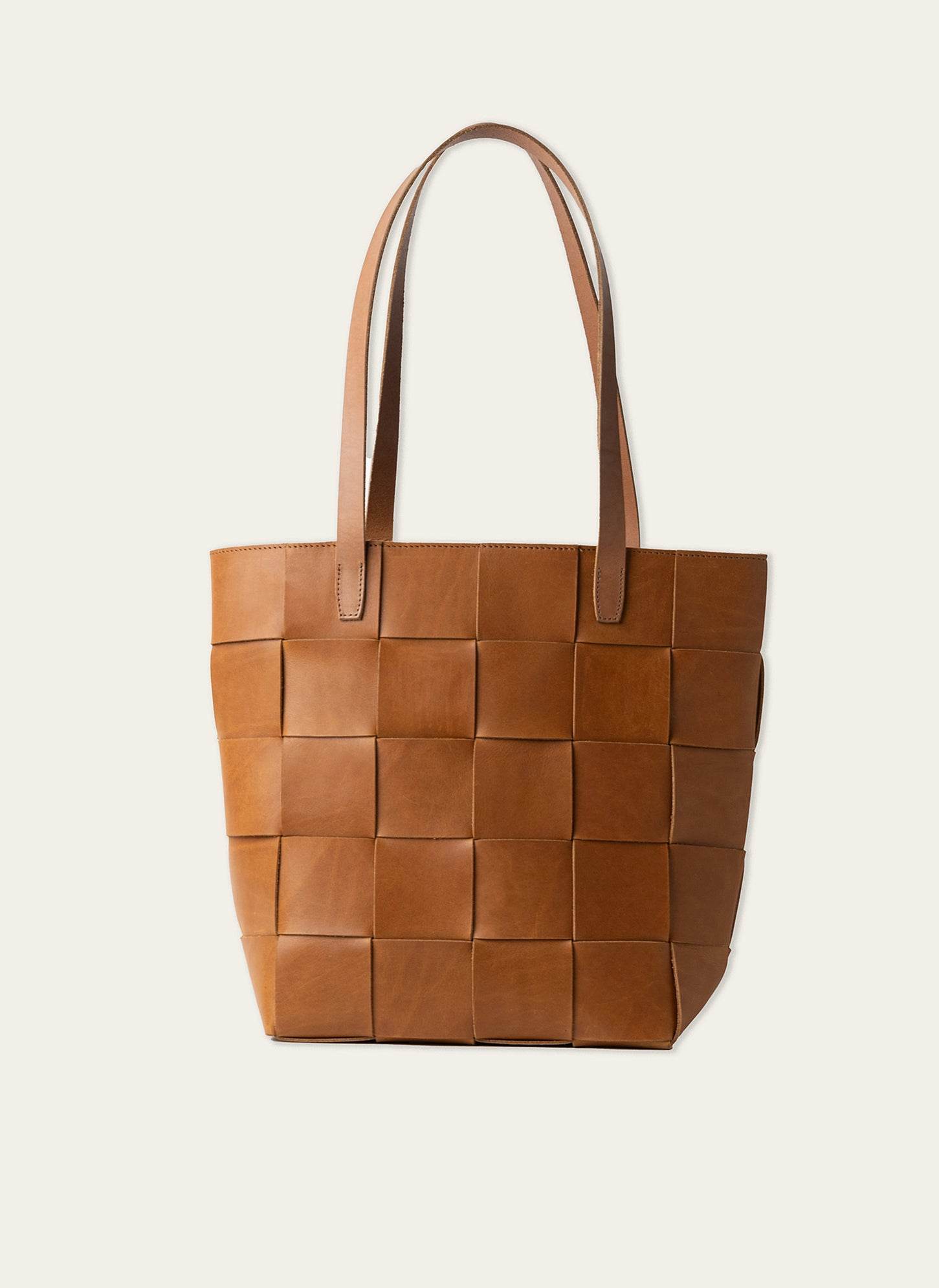 Full-grain leather woven tote bag with natural patina finish.