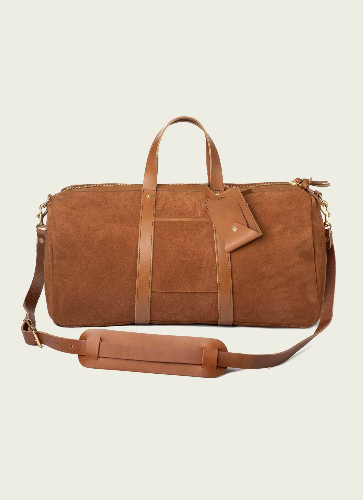 Suede Panam Duffel bag in light tan with leather handles and zipper details.
